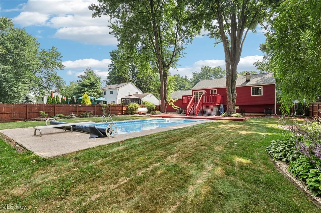 Beautifully landscaped fenced in backyard with 2 level deck and heated in-ground pool for relaxing and entertaining!