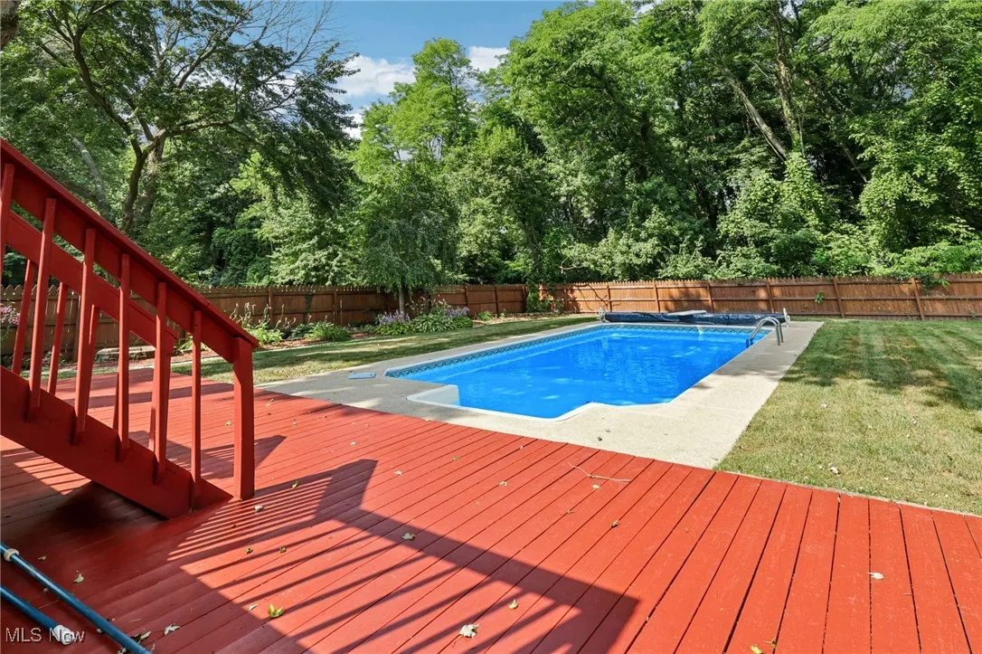 Beautifully landscaped fenced in backyard with 2 level deck and heated in-ground pool for relaxing and entertaining!