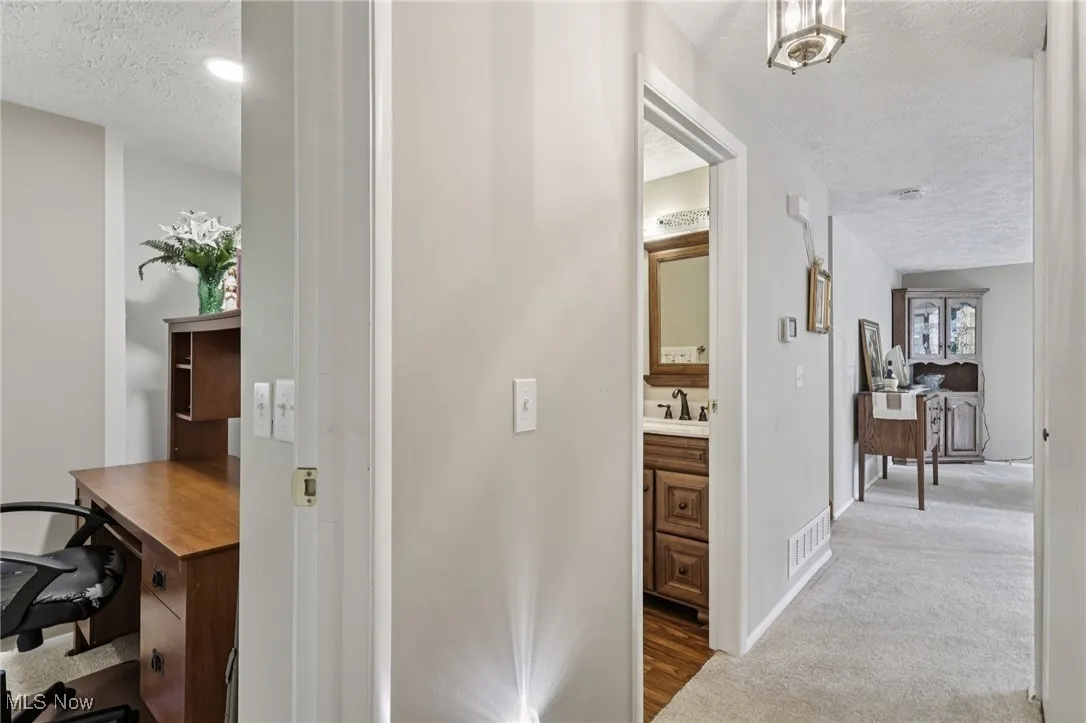 Hallway provides entry to fullbath room and bedrooms