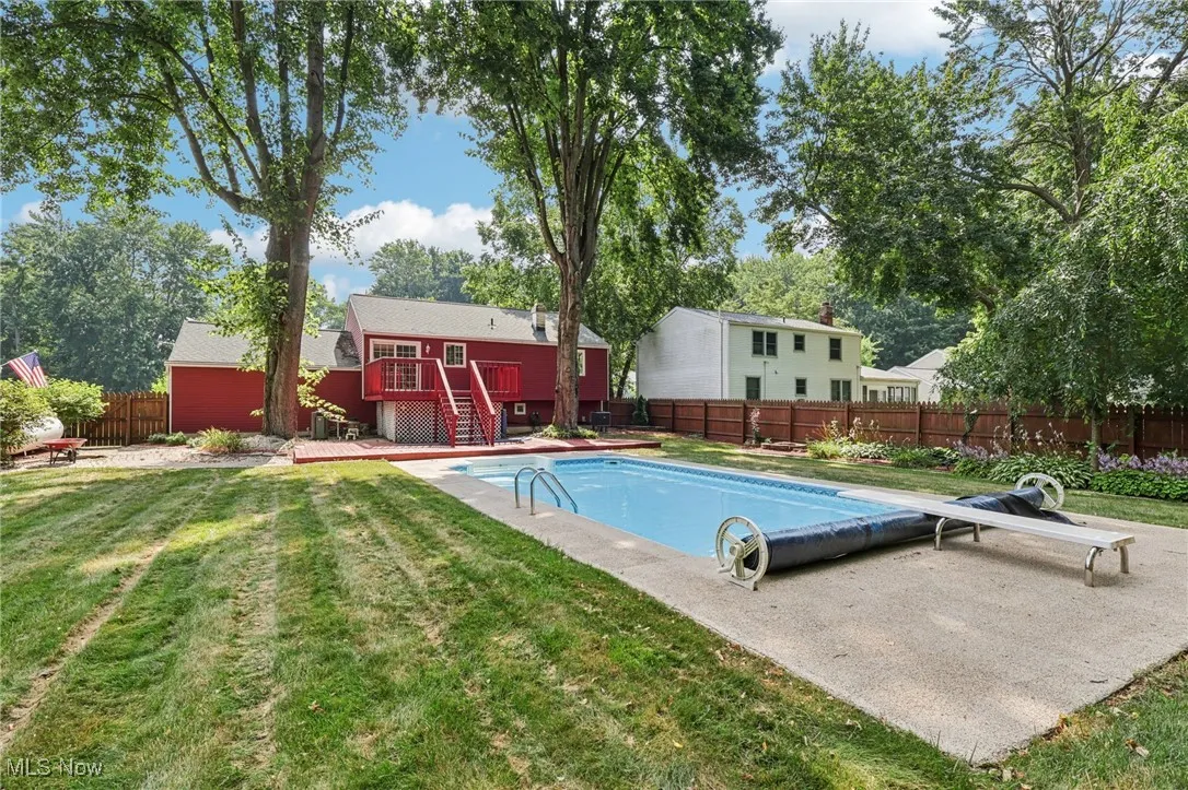 Pool with diving board, ladder and stairs to enter pool and Solor summer cover.