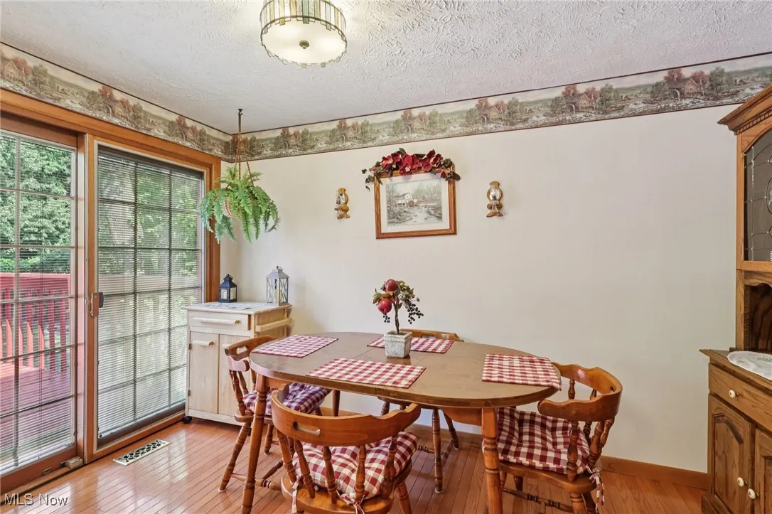 eat in kitchen with slider leading to two level deck and beatifully landscaped backyard and heated in ground pool.