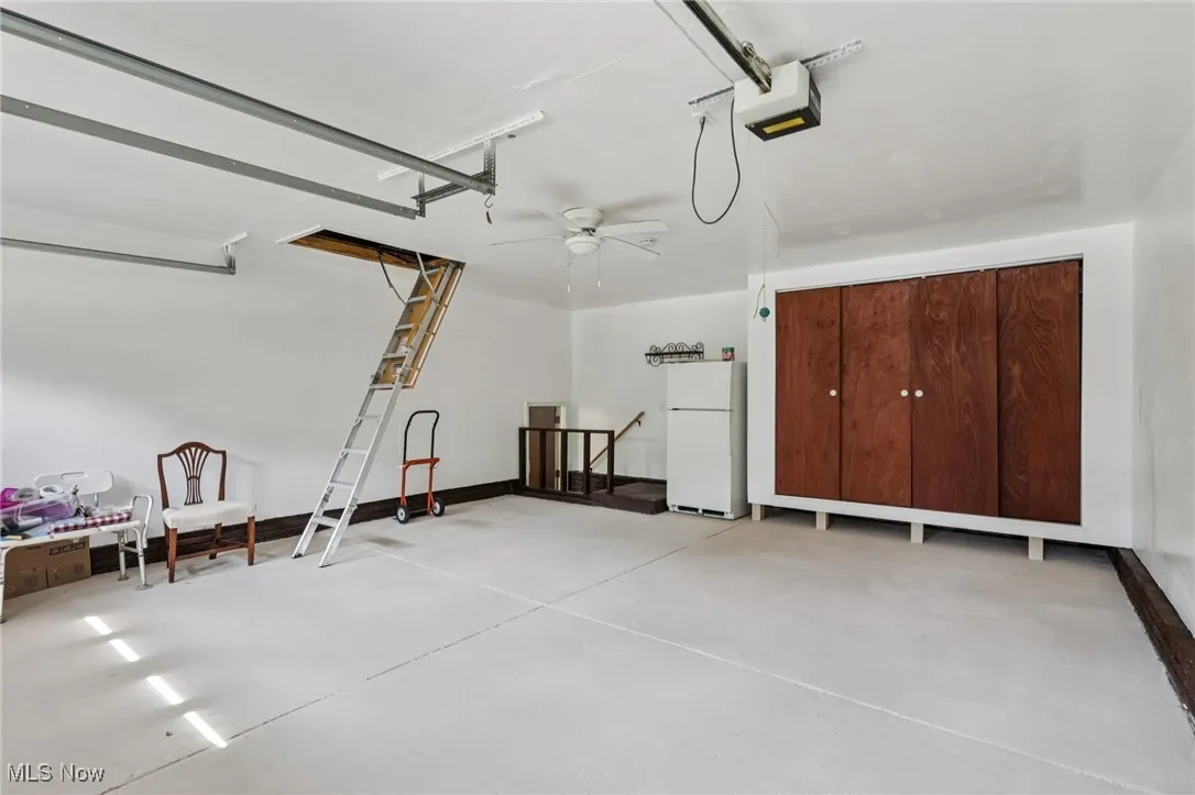 2 Car garage with extra cabinet for storage and stairs leading into the home. In the attic you will find lighting and flooring for extra storage