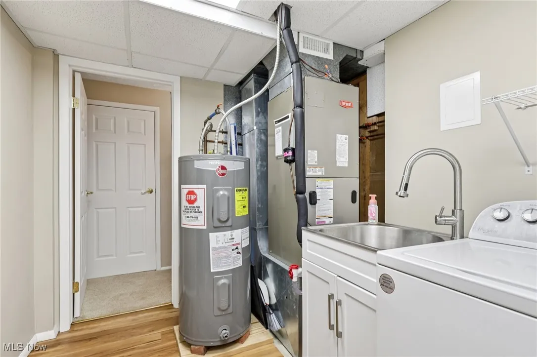 laundry room with electric dryer and washer and utitlity tub. All appliances stay!
