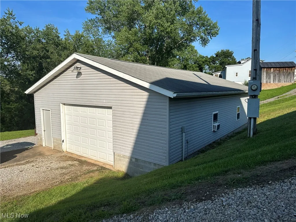 Detached garage featuring parking space and access to the driveway.