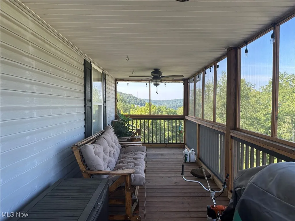 Screened in porch with a view to the back yard.