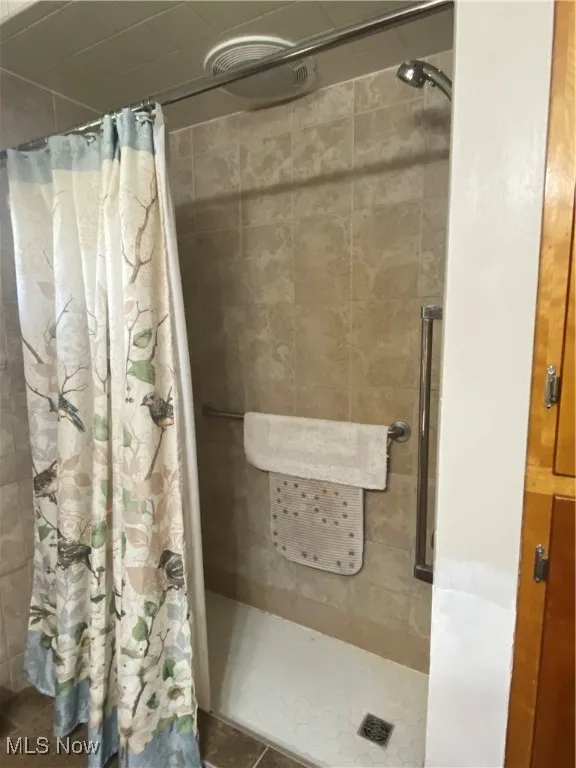 Full bathroom featuring a stall shower