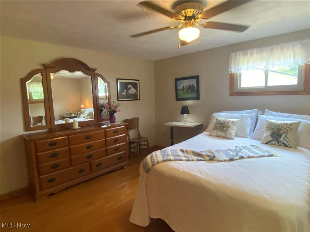 Bedroom with light wood-type flooring and a ceiling fan