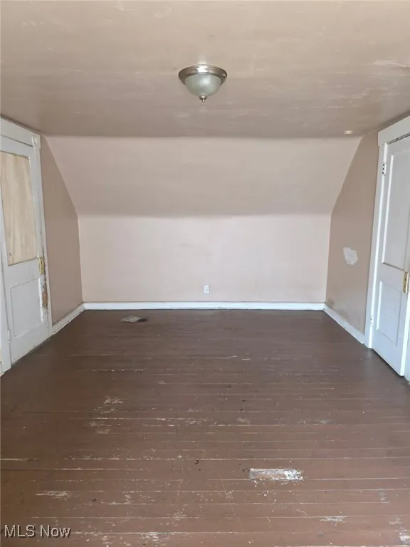 Additional living space featuring vaulted ceiling and hardwood / wood-style flooring