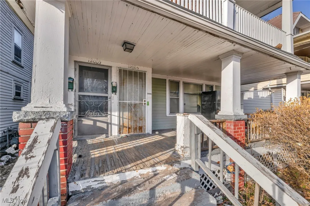 View of exterior entry with a porch