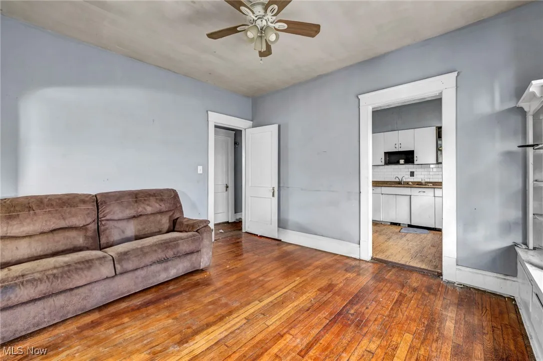 Living area featuring hardwood / wood-style flooring and ceiling fan