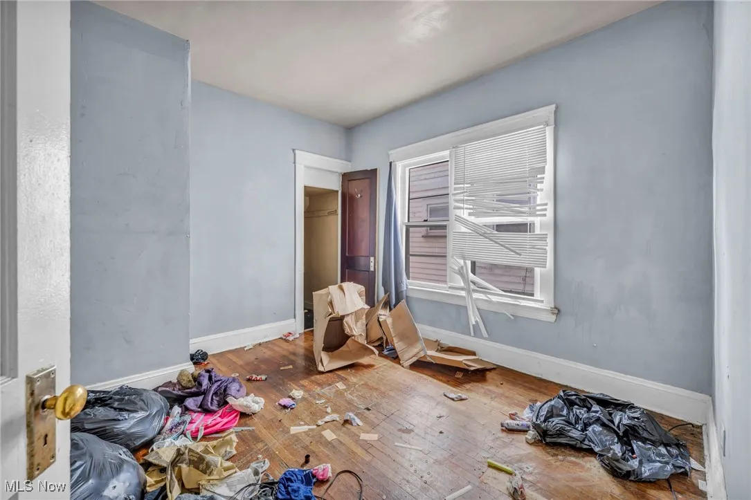 Bedroom with baseboards and hardwood / wood-style floors