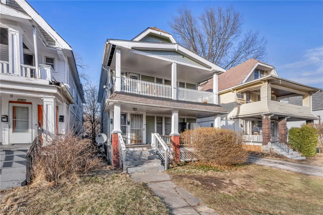 View of front of house featuring a balcony and a porch
