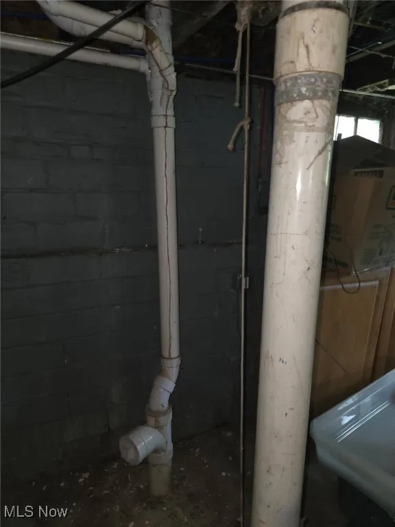 Below grade area featuring concrete block wall (Updated Plumbint)