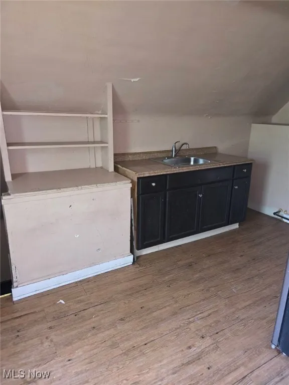 Kitchen with wood finished floors and dark cabinetry (3rd Floor)