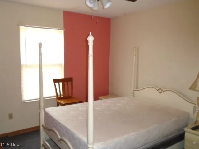 Bedroom featuring a ceiling fan and baseboards