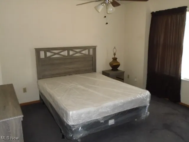 Carpeted bedroom with billiards table and baseboards
