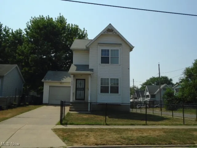 Traditional home with a fenced front yard and driveway