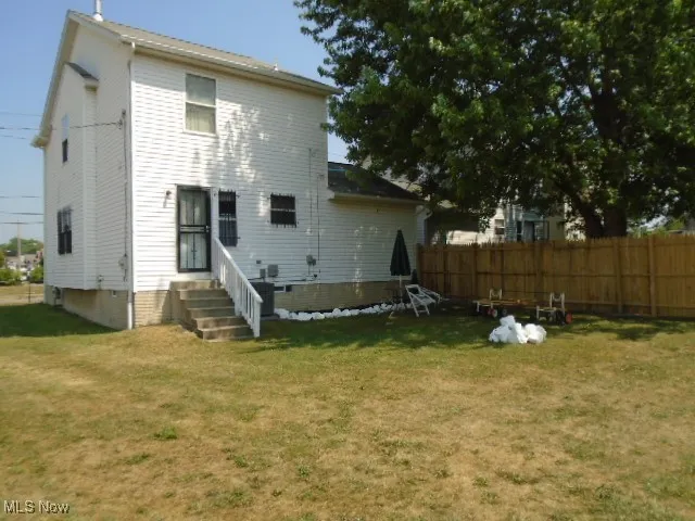 Rear view of property with entry steps