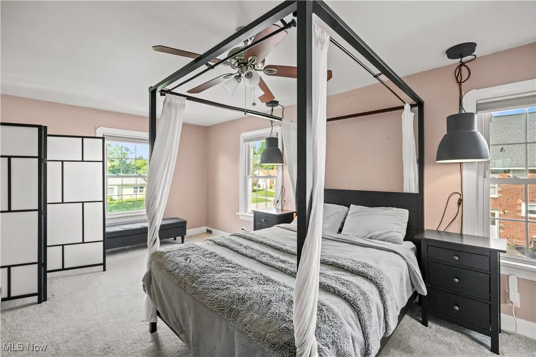 Carpeted bedroom featuring baseboards