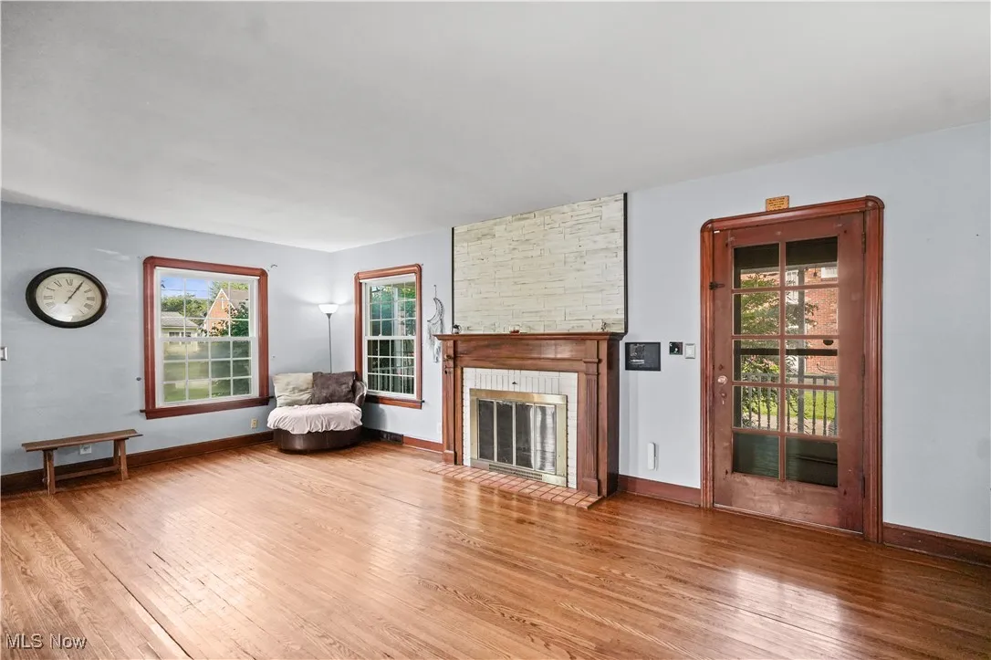 Unfurnished living room with wood finished floors and a fireplace