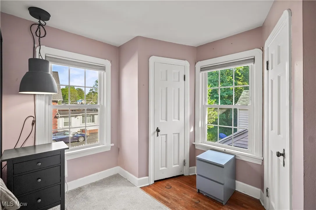 Bedroom featuring multiple windows and wood finished floors