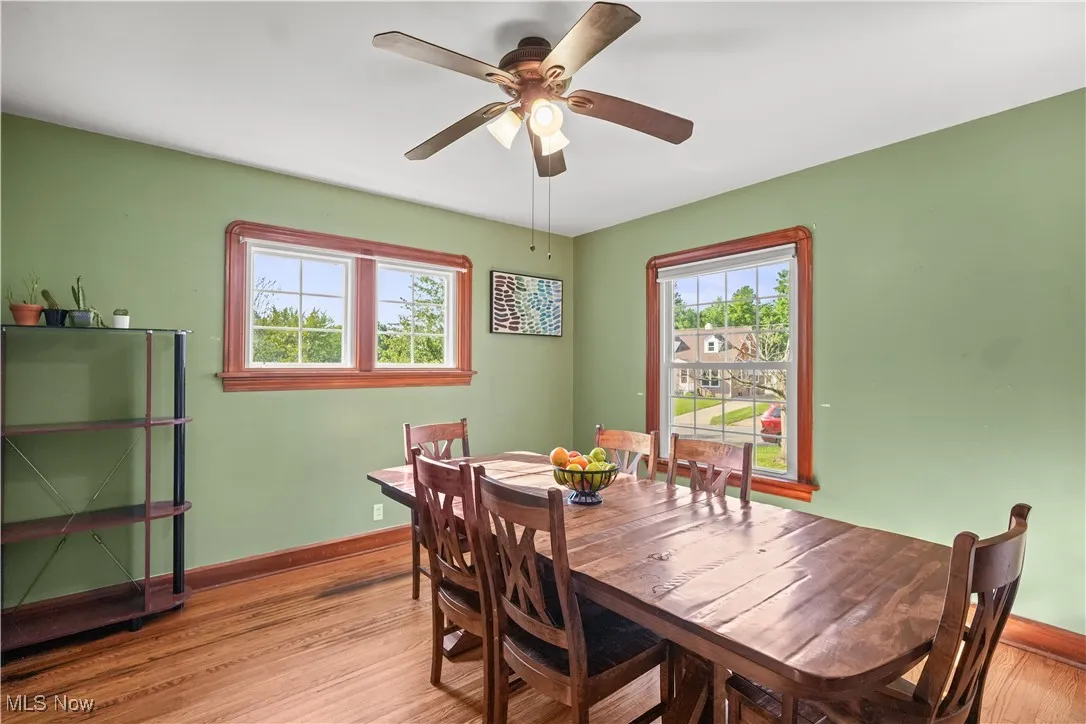 Dining area with light wood-type flooring and a ceiling fan