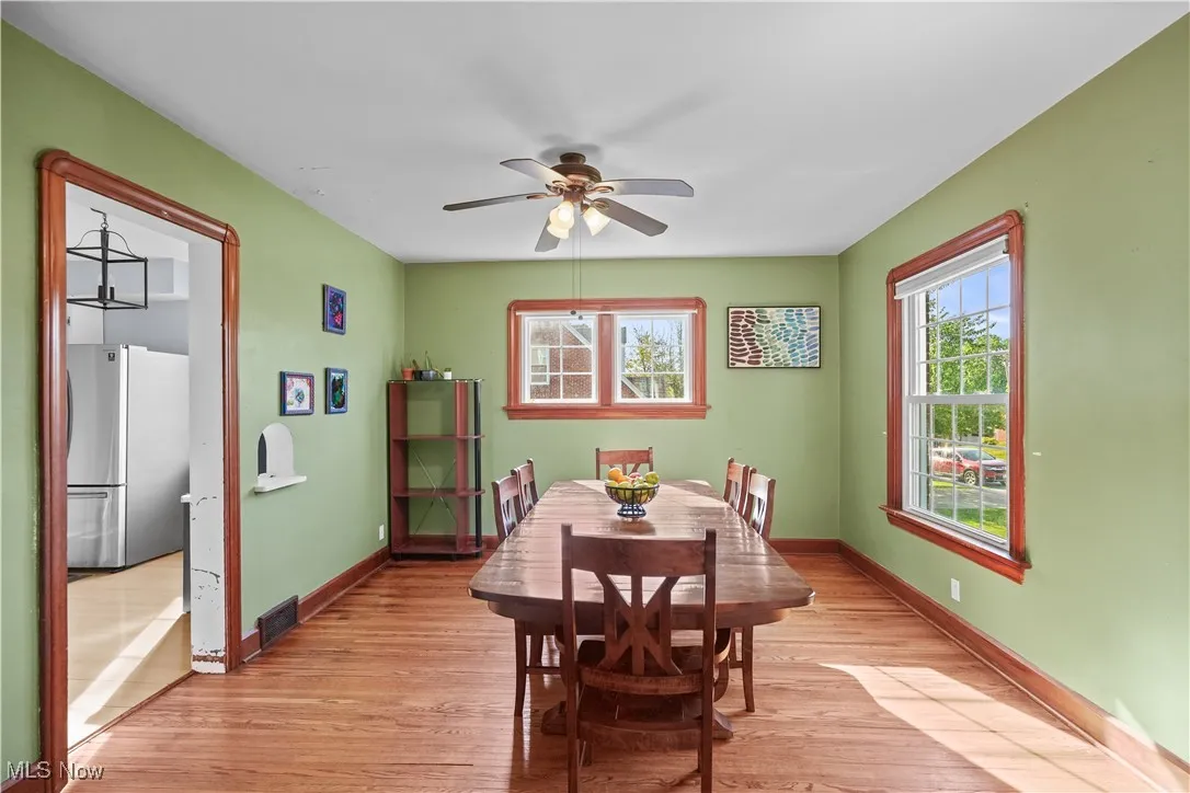 Dining space featuring a ceiling fan and light wood-style floors