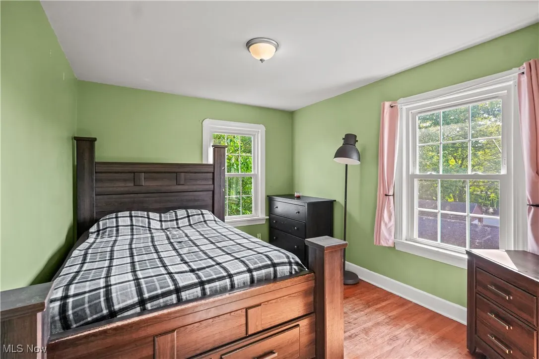 Bedroom with baseboards and light wood finished floors
