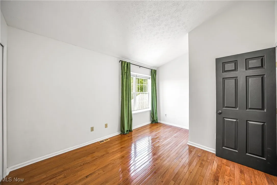 Guest Bedroom with Hardwood Flooring