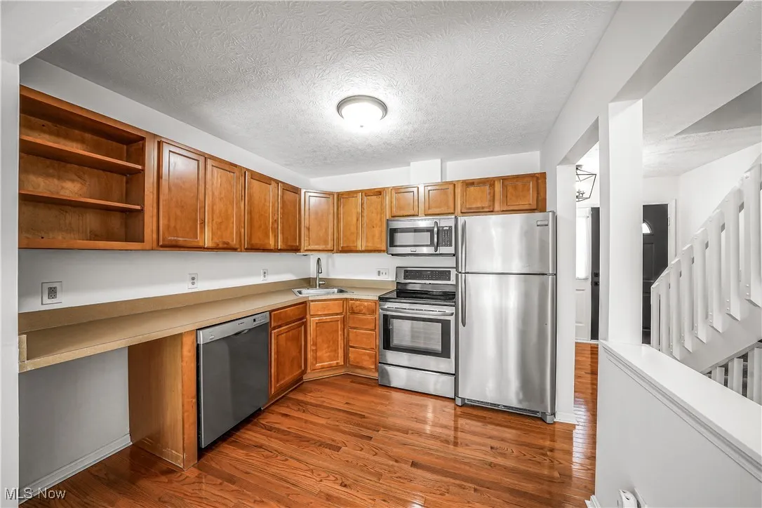 Open Concept Kitchen with Stainless Steel Appliances and Hardwood Flooring