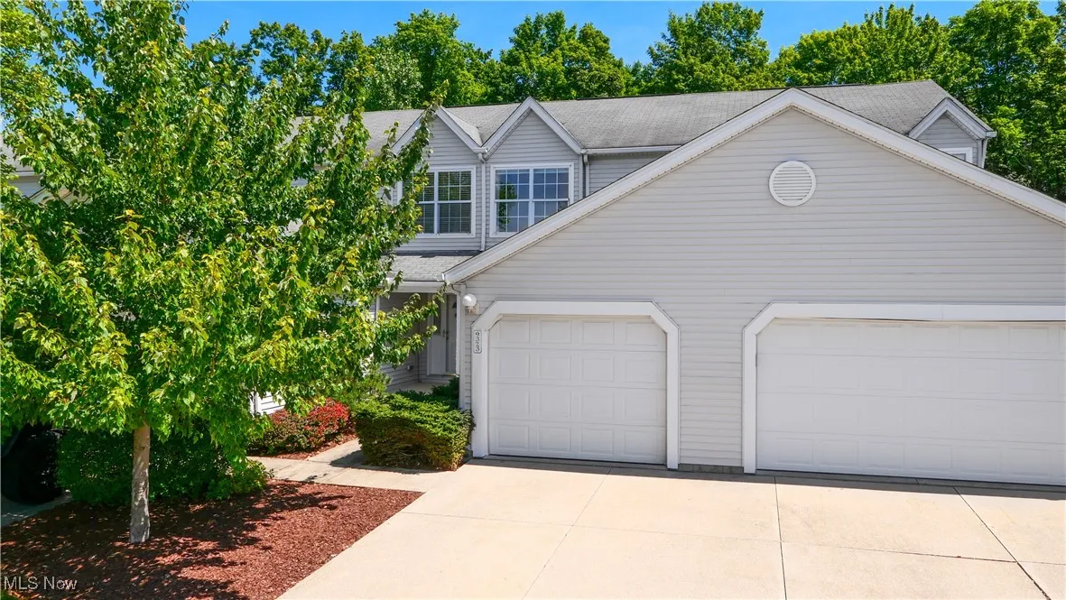 Charming Front Entrance with One Car Attached Garage and Deep Driveway