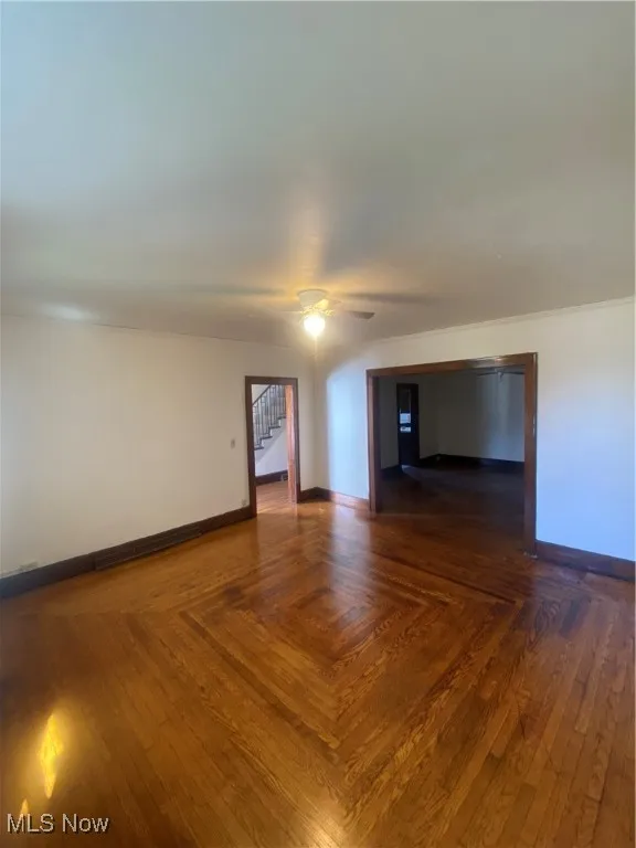 Empty room with stairs and ceiling fan