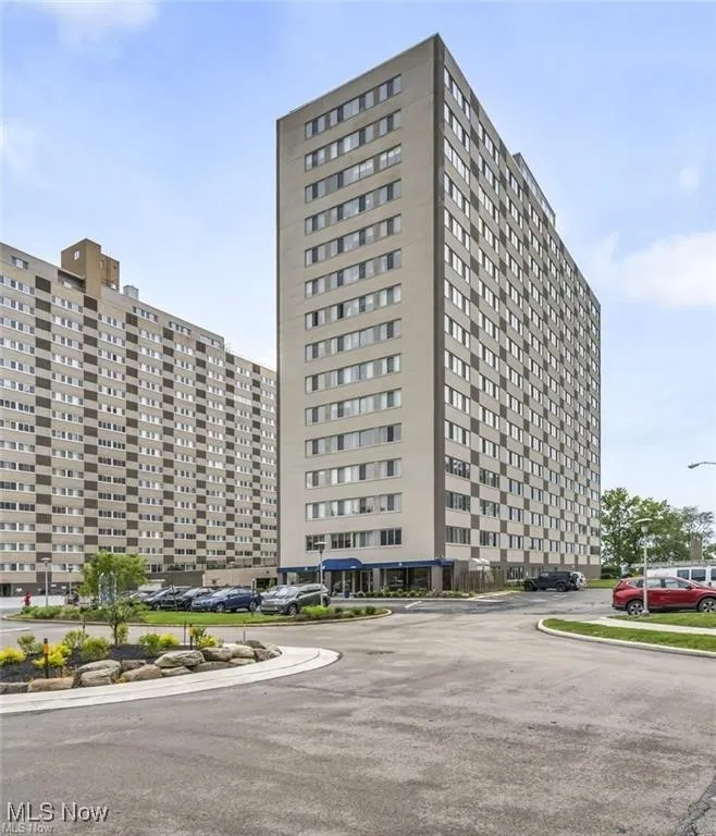 View of property with uncovered parking
