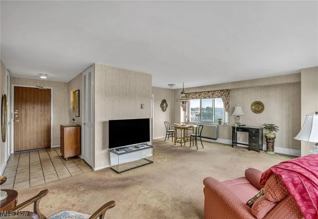 Living room featuring wallpapered walls and carpet floors