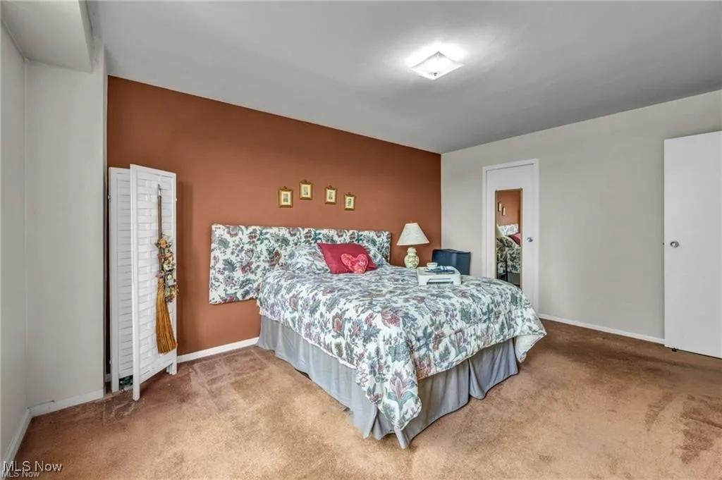 Carpeted bedroom featuring baseboards