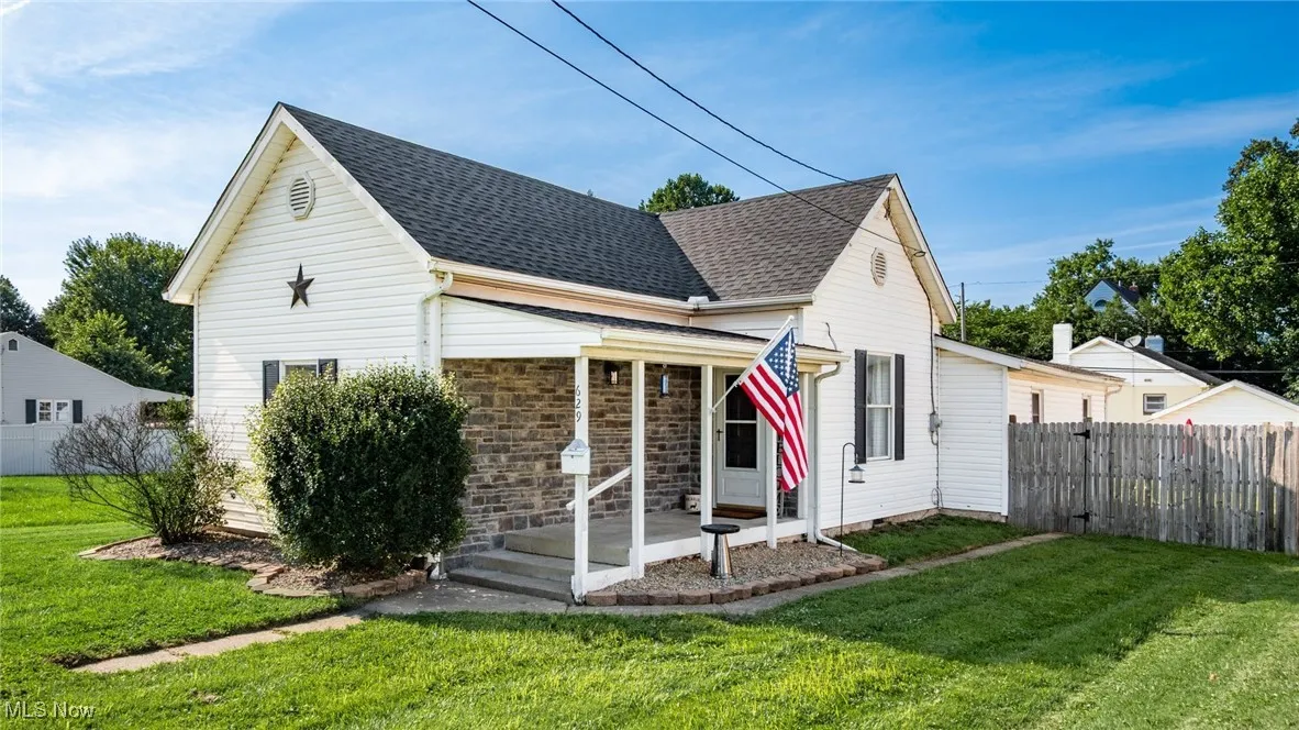 View of front of home with roof with shingles and stone siding