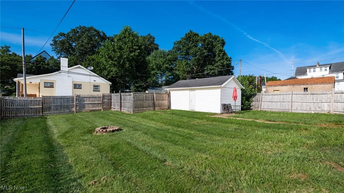 Fenced backyard with a storage shed