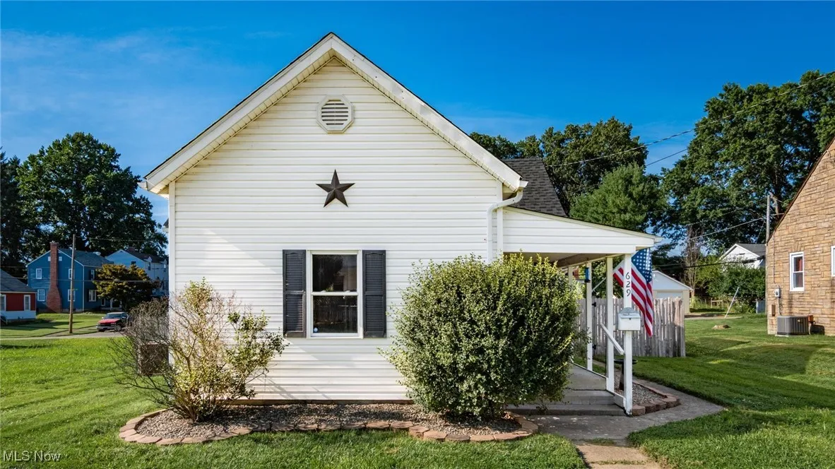 Back of property featuring a lawn