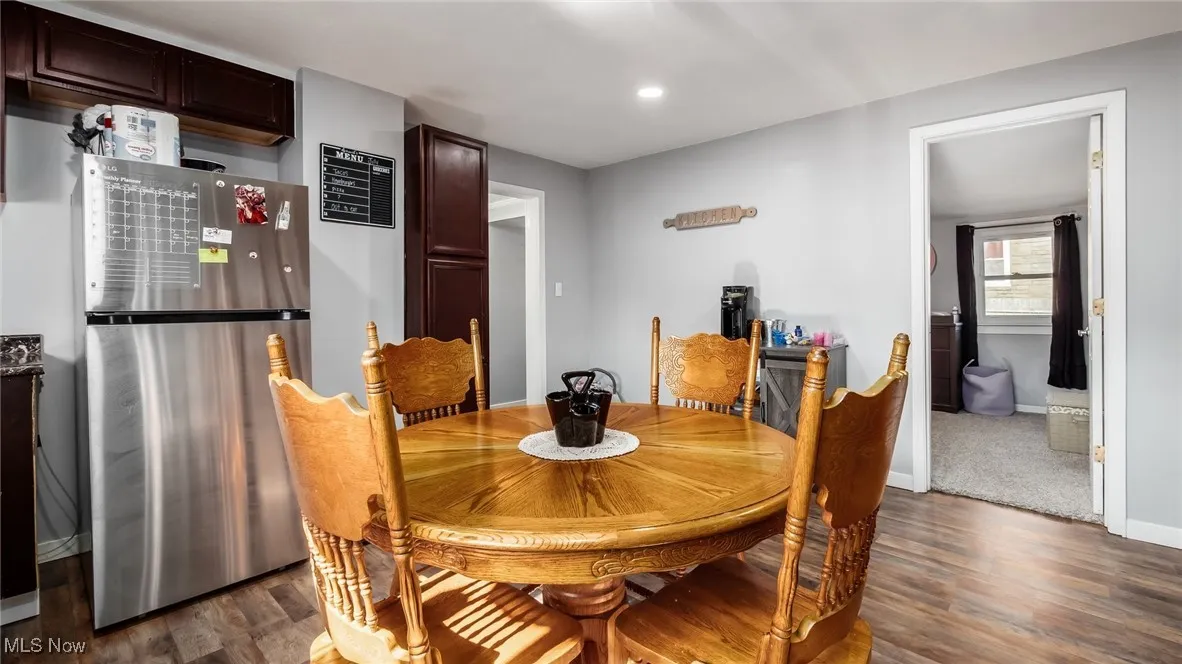 Dining area featuring dark wood-style floors and recessed lighting