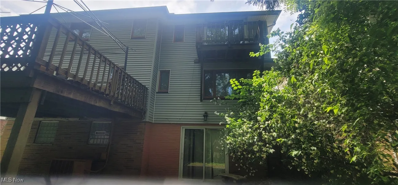 Back of property featuring brick siding
