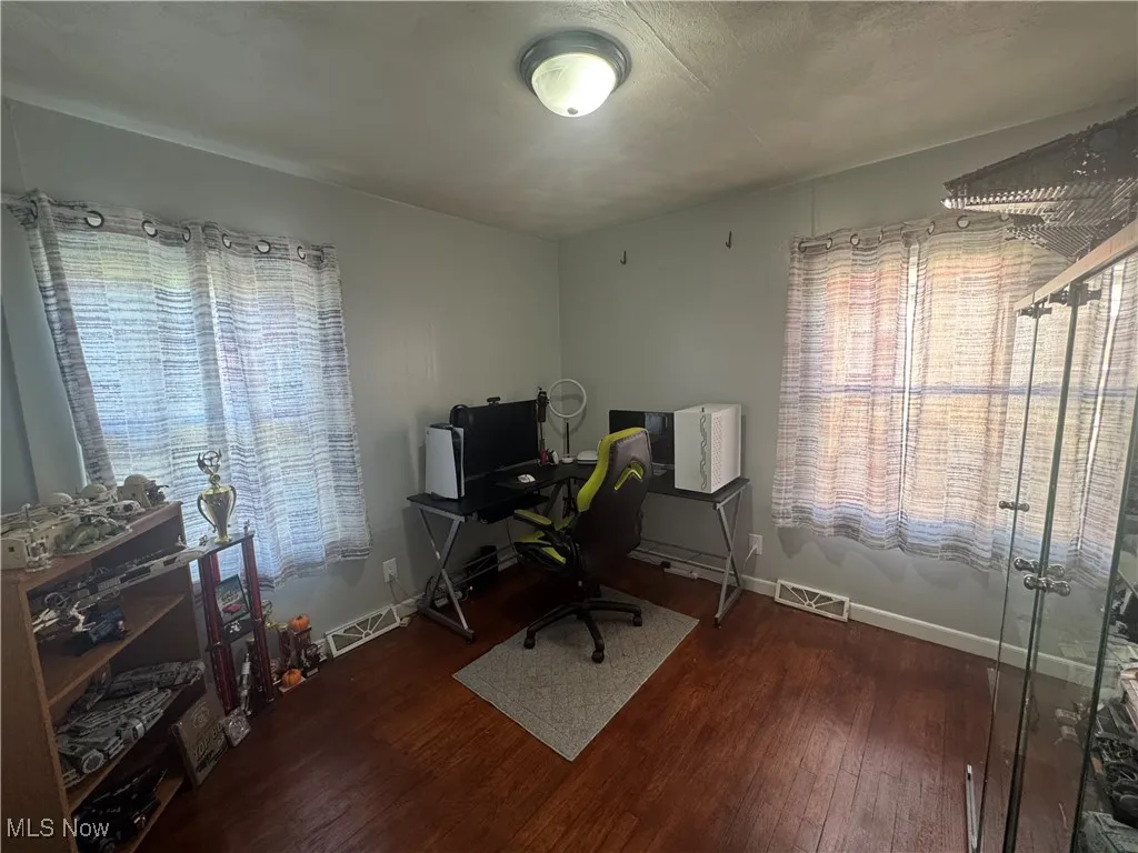 Office area with wood finished floors and baseboards