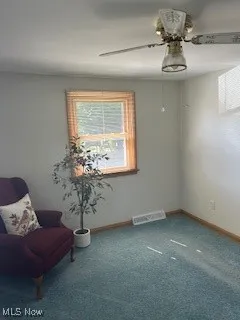 Unfurnished room featuring a ceiling fan and carpet floors