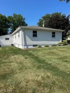 View of home's exterior featuring a yard