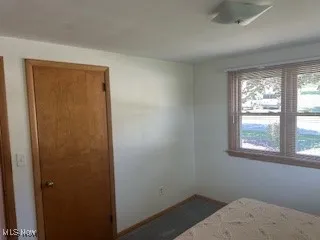 Unfurnished bedroom with baseboards