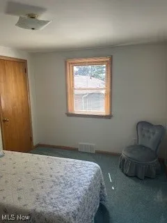 Bedroom featuring carpet floors and baseboards