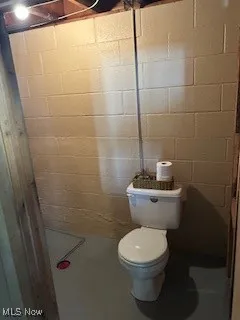 Bathroom featuring toilet and concrete floors