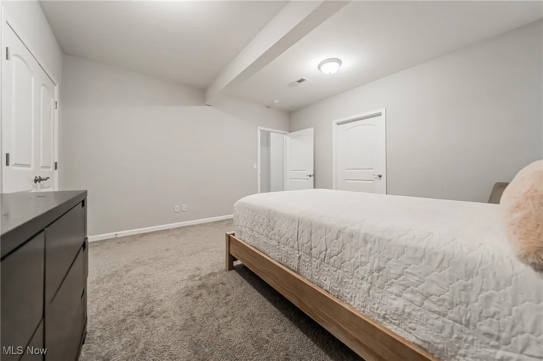 Bedroom with carpet floors and baseboards