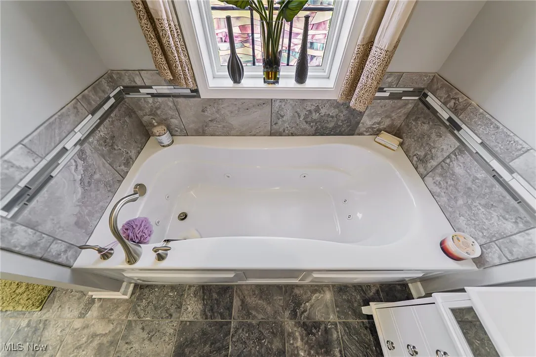 Full bath featuring a jetted tub