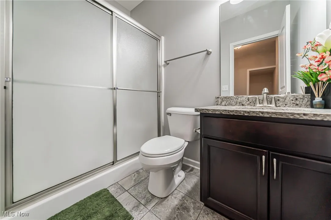 Bathroom with vanity and a shower stall