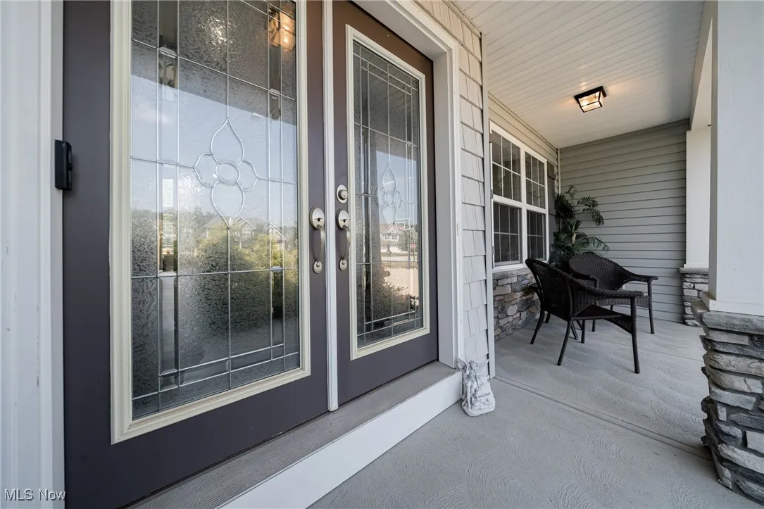 View of exterior entry with covered porch